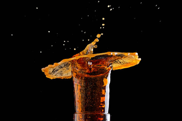 istock Beer splash in glass on black background 2159019549