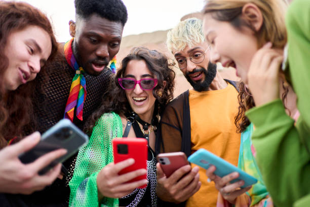 istock Side view multiracial smiling group young generation z leaning brick wall using phones outdoor. 2159020300