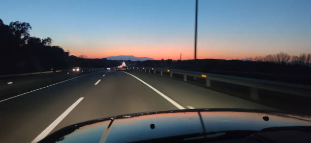 istock driving the car at night in the road 2159020919