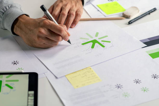 istock Close-up shot of a graphic designer making notes on logo designs, designing logos, and showcasing the corporate identity and logo design process. 2159021565