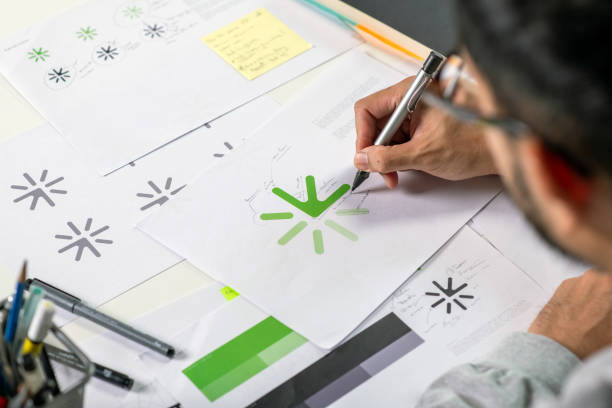 istock Close-up shot of a graphic designer making notes on logo designs, designing logos, and showcasing the corporate identity and logo design process. 2159021578