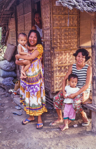 Romblon, Philippines - June 16, 2024: Women with children outside a house in Santa Fe city, Tablas island
