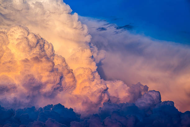 istock Large Cumulonimbus calvus clouds lit by setting summer sun.. 2159022900