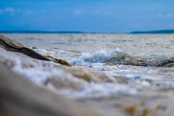 Rocky shore with sea waves at sunny day