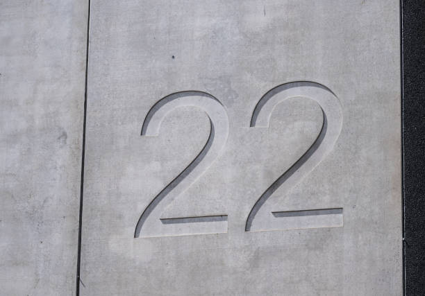 The number 22 embedded into a concrete facade.