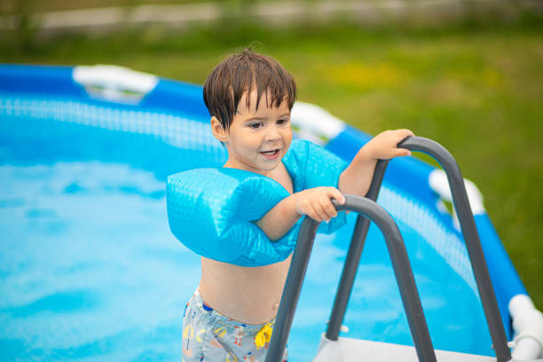 istock Getting ready to get into the swimming pool 2159024380