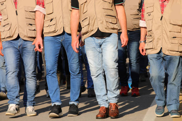 istock workers in brown vests walking during a strike participating in a protest demonstration 2159024405