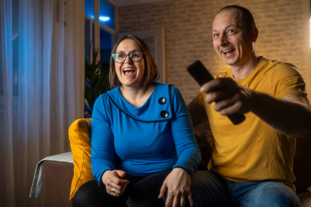 istock Couple at home watching TV 2159025383