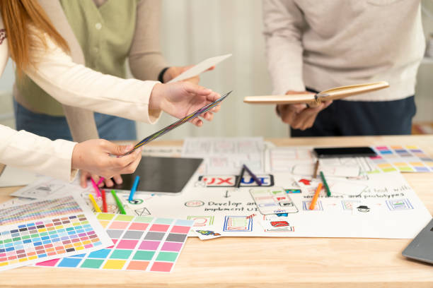 istock A team of UI/UX web designers is working together to develop a mobile responsive website with preview. Website development concepts UI UX 2159025983
