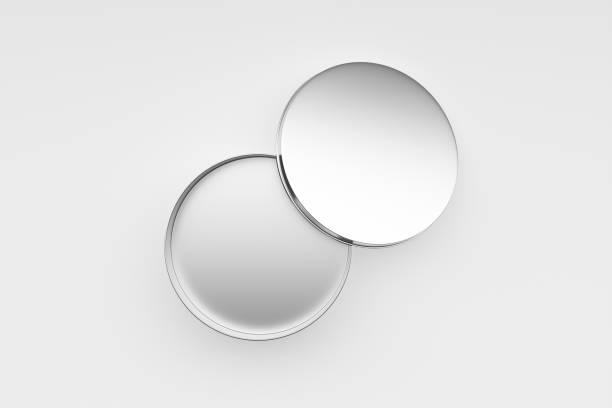 Opened round aluminum metal tin box on white background.