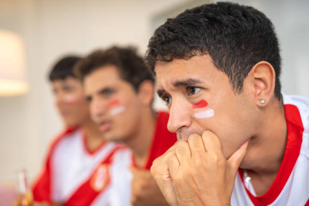 istock Nervous friends watching a soccer game 2159029620