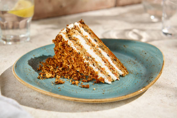 istock Sunlit Slice of Authentic Carrot Cake on a Beige Table Top 2159032727