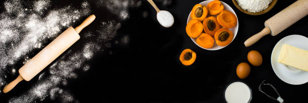 istock Ingredients for making apricot pie or cake on the black background. Copy space. Top view. 2159032762