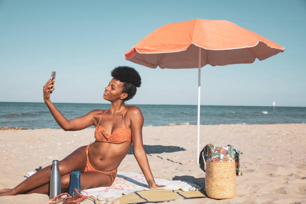 istock Woman sunbathing and shoot a selfie 2159032881