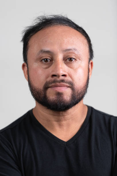 istock Serious bearded mature hispanic man posing on gray background 2159033209