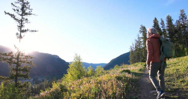 istock Mature male hiker explores pathway at sunrise 2159033480