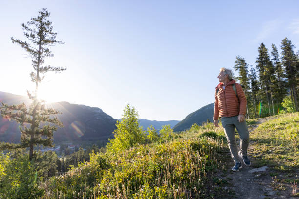 istock Mature male hiker explores pathway at sunrise 2159033553