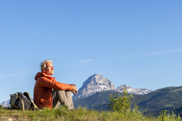 istock Mature male hiker rests in meadow 2159033554