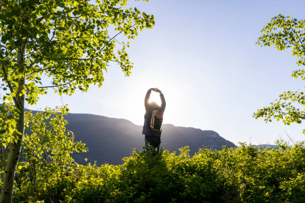 istock Mature woman stretches in mountain meadow 2159033601