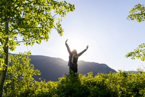 istock Mature woman stretches in mountain meadow 2159033640