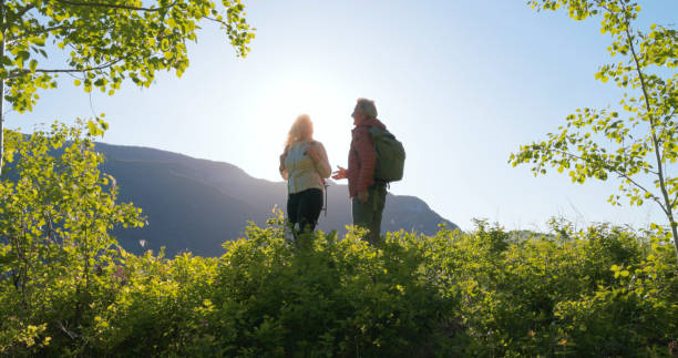 istock Mature couple hike in meadow 2159033806