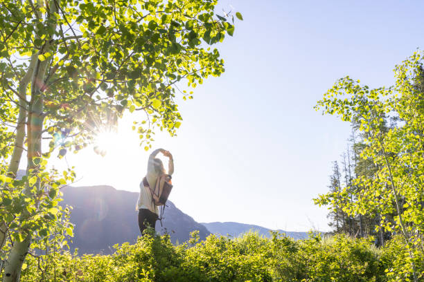 istock Mature woman stretches in mountain meadow 2159033981