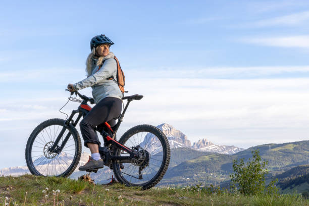 istock Mature female mountain biker in mountain meadow 2159034062