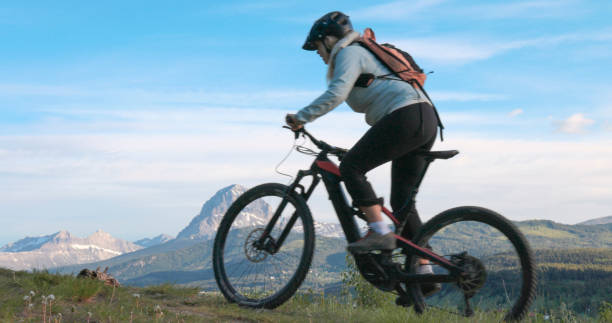 istock Mature female mountain biker in mountain meadow 2159034085