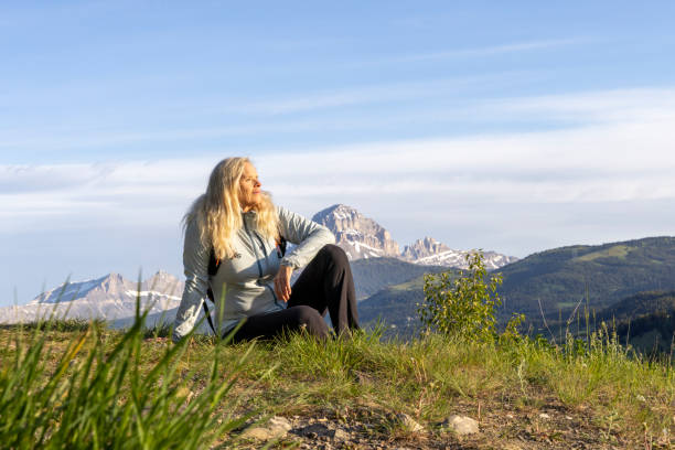 istock Mature female hiker rests in meadow 2159034152