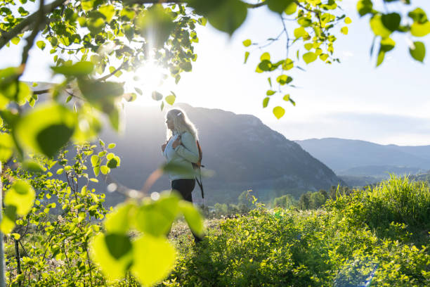 istock Mature female hiker explores meadow 2159034624