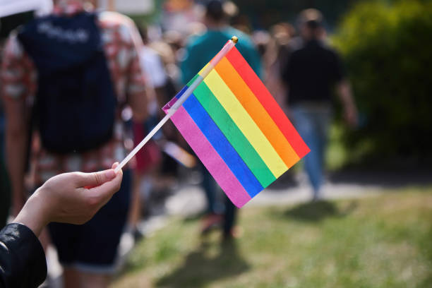 istock Pride Celebration. A person holds a rainbow pride flag 2159037993