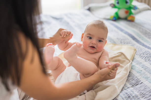 istock Woman playing with newborn baby 2159040015