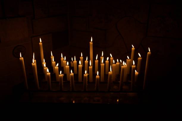 istock Burning candles in dark room 2159040093