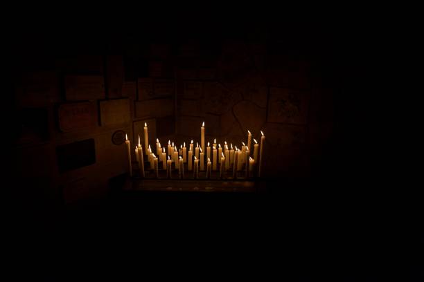 istock Burning candles in dark room 2159040180