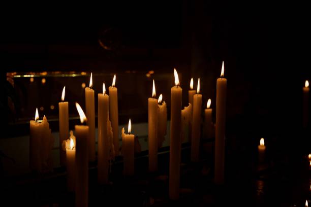 istock Burning candles in dark room 2159040237