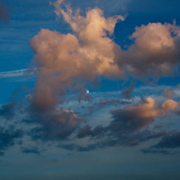 istock Moon peeping out of a dramatic cloud formation 2159040509