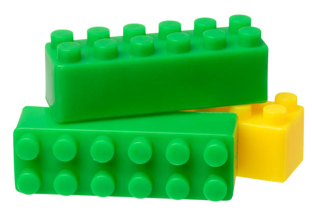 Green and yellow plastic construction set parts on isolated background