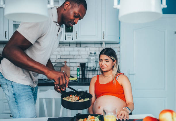 istock Man cooking for his pregnant wife 2159042233