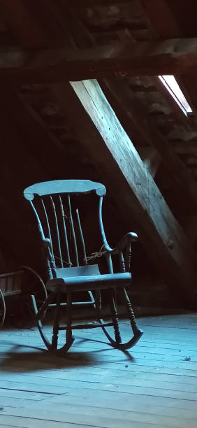 istock rocking wood chair with lateral light 2159044081