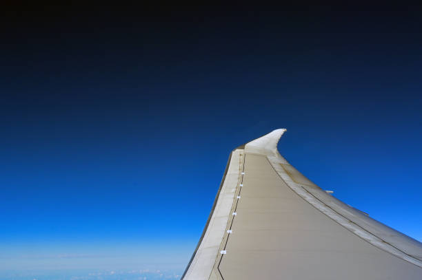 istock Aircraft wing isolated against a deep blue sky 2159044997