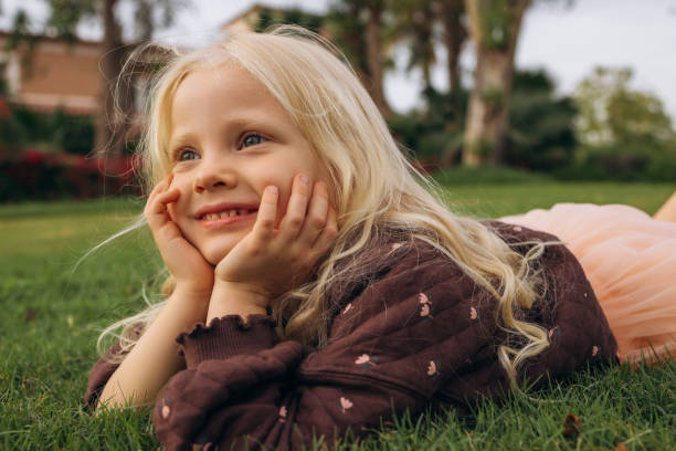 istock Contented Girl Resting on Grass 2159050592