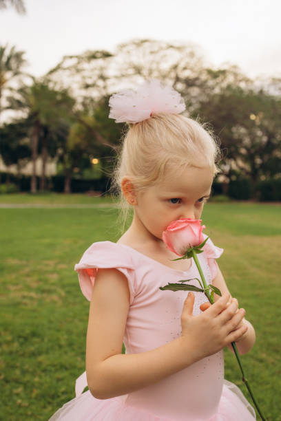 istock Girl in Pink Tutu Savoring a Rose 2159051039