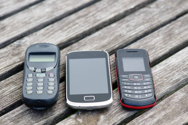 Old cell phones on old weathered wooden table