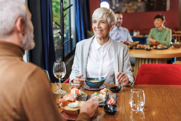 istock Two people in elegant clothes enjoying a sushi meal at a restaurant 2159052085