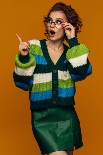 istock Stylish Woman in Striped Sweater Making Surprised Gesture 2159052816