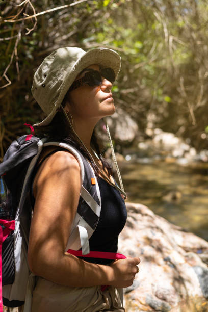 istock Woman Hiking in Forest with Backpack and Hat 2159062086