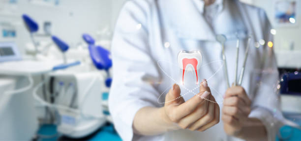 istock The dentist shows a tooth with an instrument in his hand . 2159062917