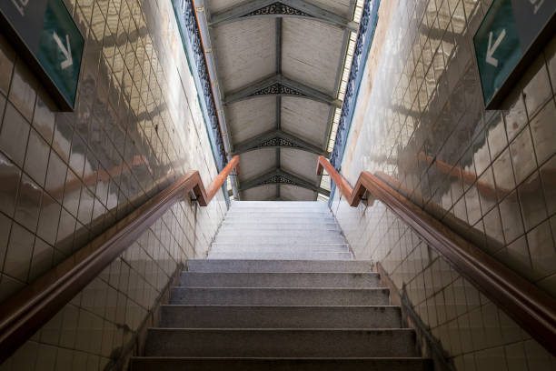 istock Stairs going up with railings and walls on the sides with two direction arrows. 2159063988