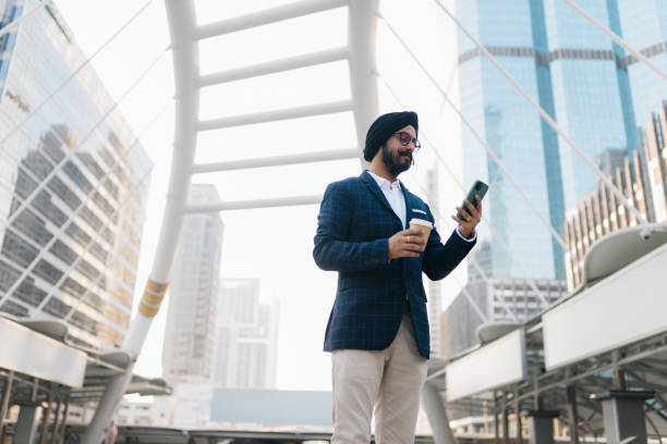 istock Indian entrepreneur using cell phone on the street 2159064811