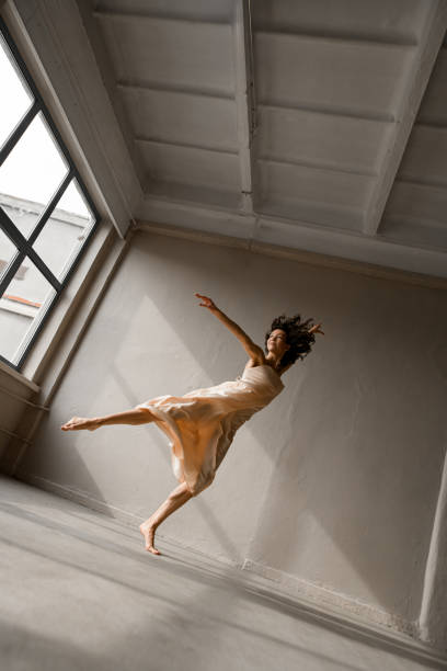 istock Young slender dancer stands on tiptoe and bent at the knee 2159065923